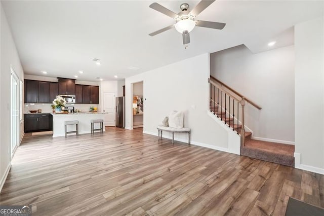 unfurnished living room featuring light hardwood / wood-style floors and ceiling fan