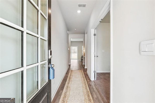 corridor with wood-type flooring