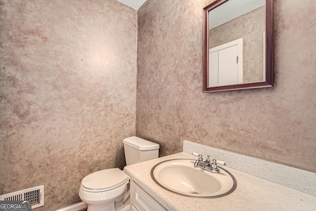 bathroom featuring vanity and toilet