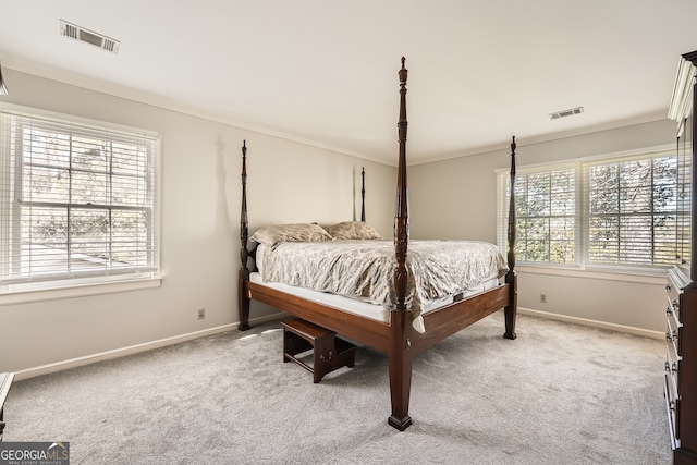 bedroom with carpet flooring and crown molding