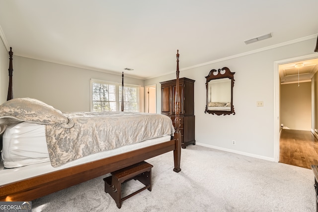 bedroom with light wood-type flooring, a walk in closet, a closet, and ornamental molding