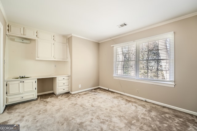 interior space featuring ornamental molding, light carpet, and plenty of natural light