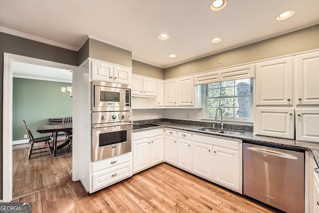 kitchen with white cabinetry, sink, stainless steel appliances, light hardwood / wood-style flooring, and crown molding