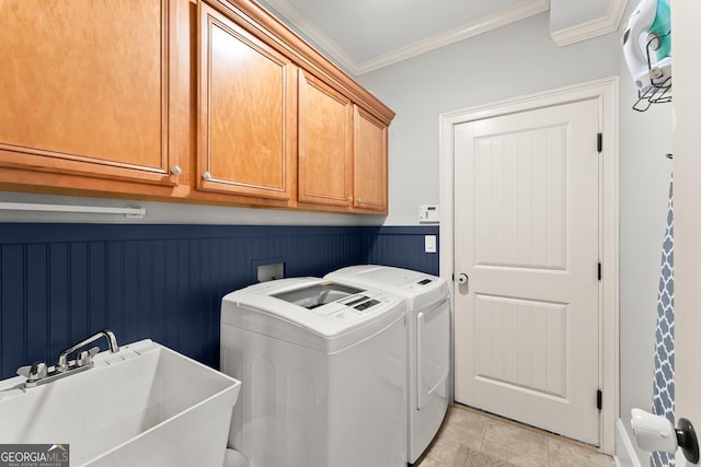 laundry room with cabinets, sink, ornamental molding, light tile patterned floors, and separate washer and dryer