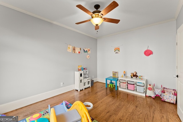 game room with crown molding, hardwood / wood-style floors, and ceiling fan