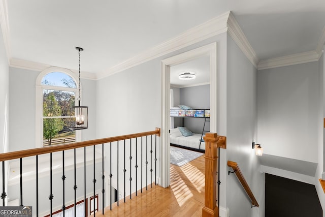 corridor featuring a notable chandelier and ornamental molding