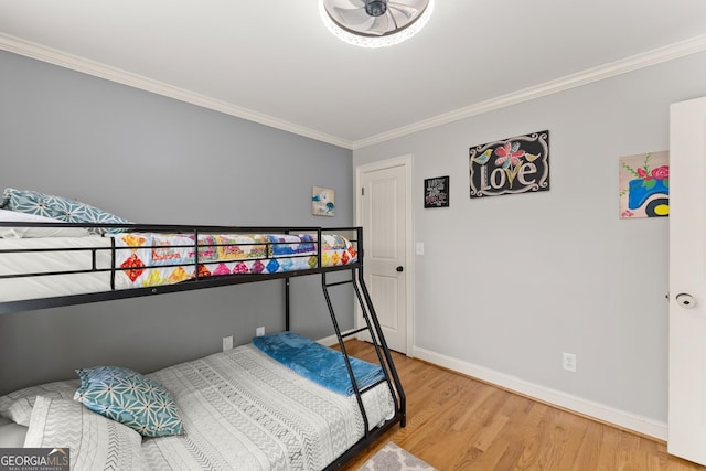 bedroom with hardwood / wood-style floors and ornamental molding