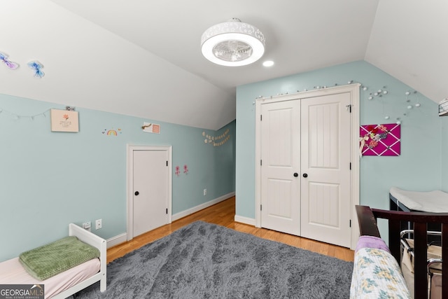 bedroom featuring wood-type flooring and vaulted ceiling