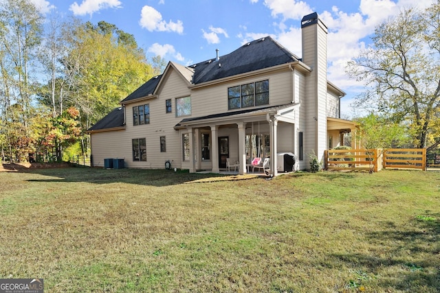 back of house featuring a lawn and a patio