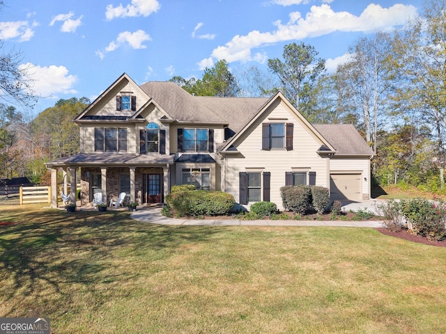 craftsman inspired home with a garage and a front yard