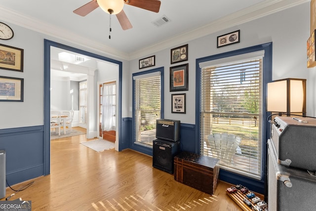 office space featuring crown molding, light hardwood / wood-style flooring, and ceiling fan