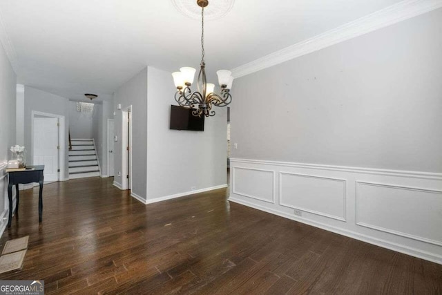 unfurnished dining area with crown molding, a chandelier, and dark hardwood / wood-style floors