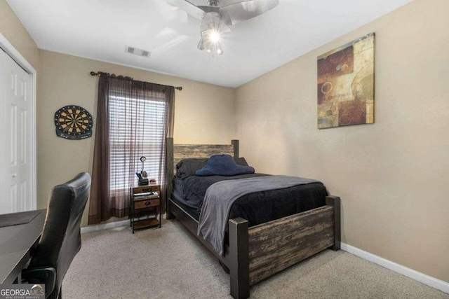 carpeted bedroom featuring a closet and ceiling fan