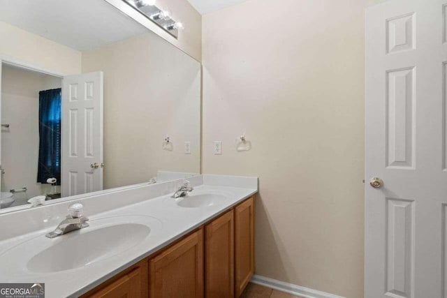 bathroom featuring vanity, toilet, and tile patterned floors