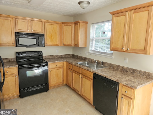 kitchen featuring a textured ceiling, sink, and black appliances