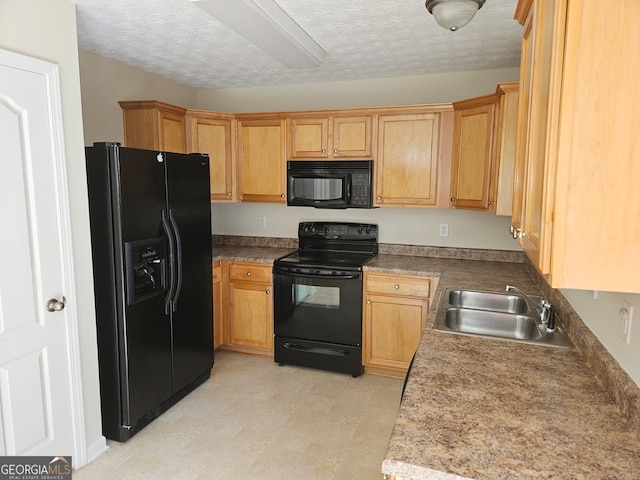 kitchen featuring black appliances, sink, and a textured ceiling