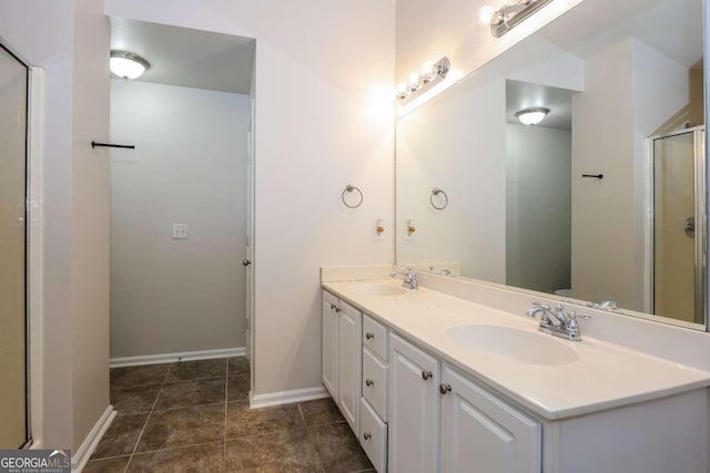 bathroom with tile patterned floors, vanity, and walk in shower