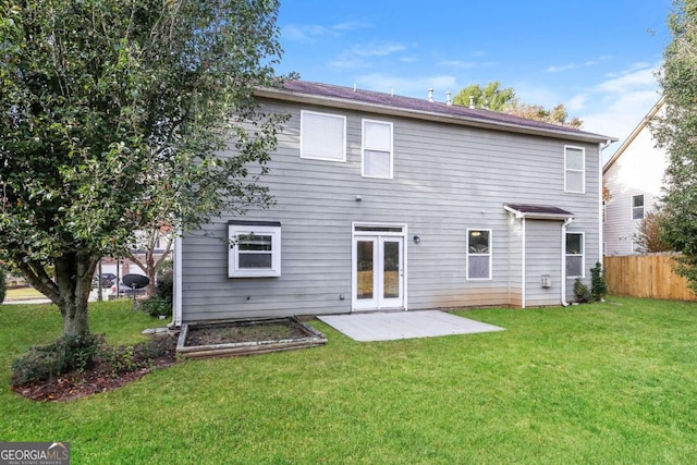 rear view of property featuring french doors, a yard, and a patio area