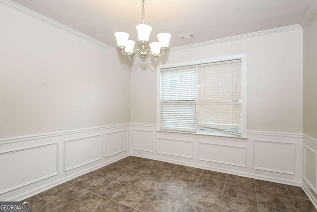 spare room with an inviting chandelier and crown molding