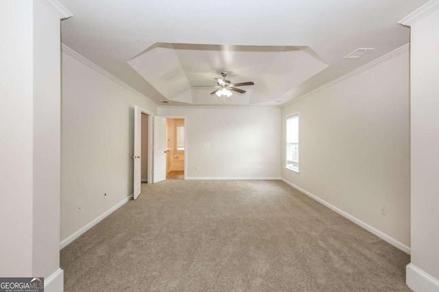 carpeted spare room featuring ceiling fan and ornamental molding