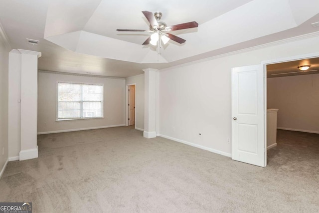 unfurnished bedroom featuring ornamental molding, ceiling fan, light colored carpet, and decorative columns