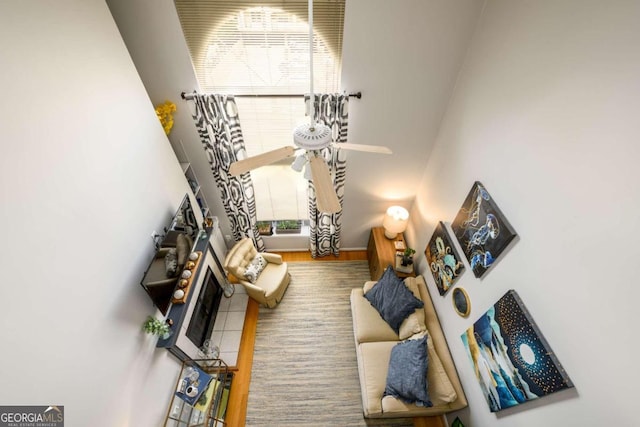 living room featuring hardwood / wood-style flooring, plenty of natural light, ceiling fan, and a fireplace