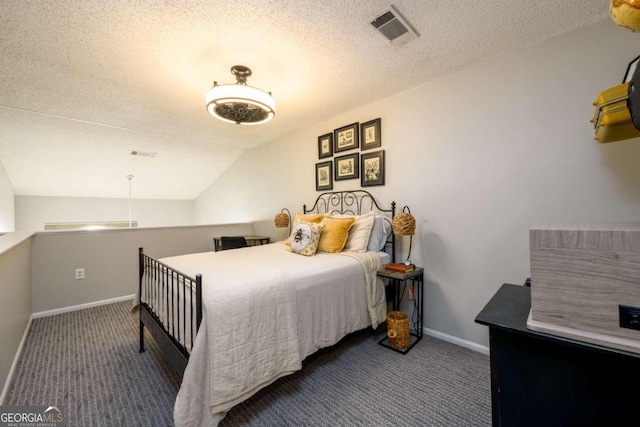 bedroom featuring dark colored carpet, a textured ceiling, and lofted ceiling