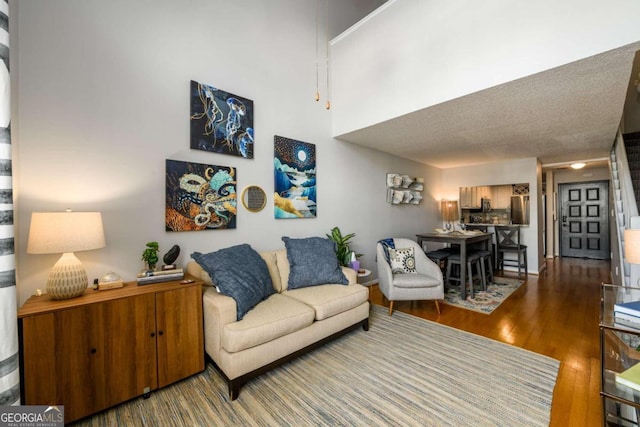 living room featuring hardwood / wood-style floors and a textured ceiling