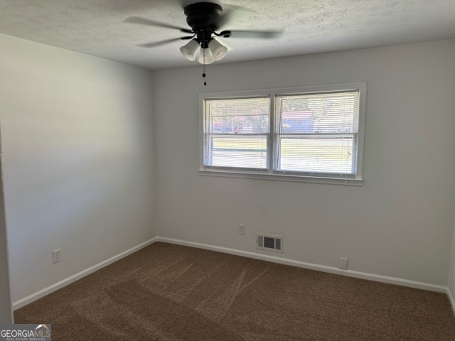 spare room with ceiling fan, carpet floors, and a textured ceiling