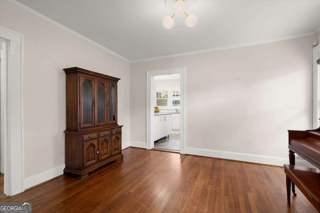 living area featuring a notable chandelier, crown molding, and dark hardwood / wood-style flooring