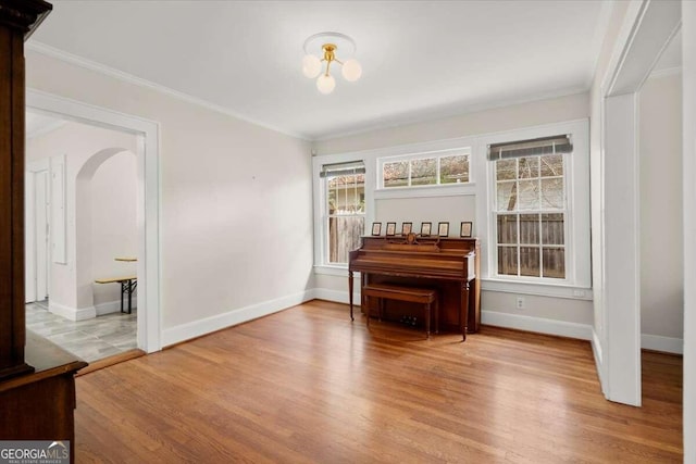 miscellaneous room featuring light hardwood / wood-style floors and ornamental molding