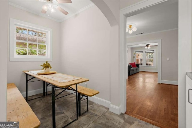 dining space with crown molding, hardwood / wood-style floors, and ceiling fan