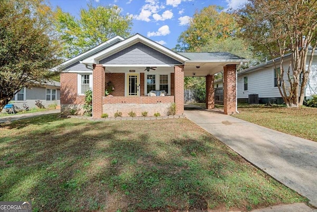 view of front of property featuring central AC, a front yard, a porch, and a carport