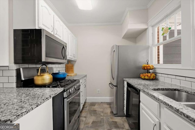 kitchen with decorative backsplash, white cabinets, and stainless steel appliances