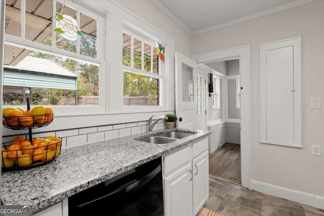 kitchen with sink, white cabinets, plenty of natural light, and black dishwasher