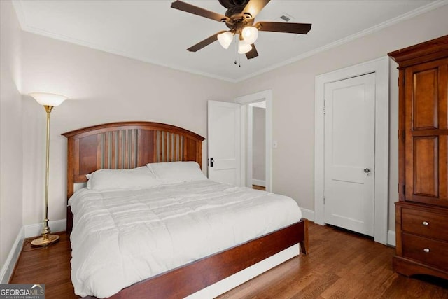 bedroom featuring ceiling fan, crown molding, and dark hardwood / wood-style flooring