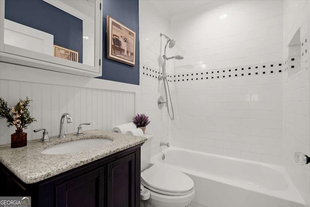 full bathroom with vanity, toilet, and tiled shower / bath