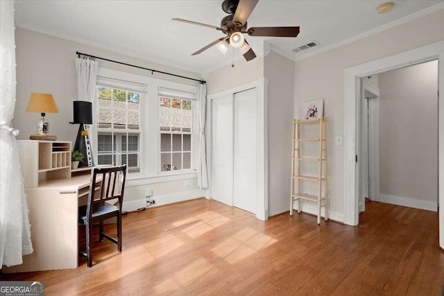 home office featuring crown molding, ceiling fan, and wood-type flooring