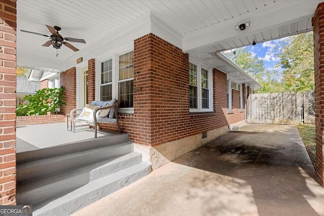 view of side of property featuring ceiling fan and covered porch