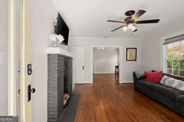 living room with ceiling fan, a fireplace, dark hardwood / wood-style floors, and ornamental molding