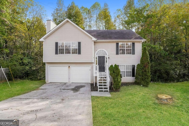 split foyer home with a garage and a front lawn