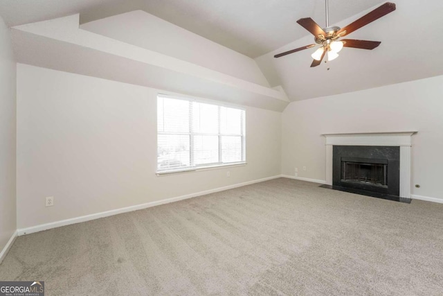 unfurnished living room with light colored carpet, vaulted ceiling, and ceiling fan