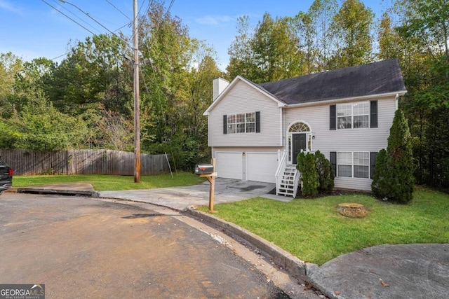 bi-level home featuring a front yard and a garage