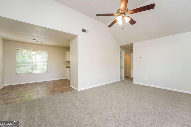 carpeted empty room with ceiling fan and lofted ceiling