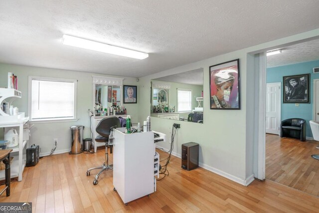 office area with hardwood / wood-style floors and a textured ceiling