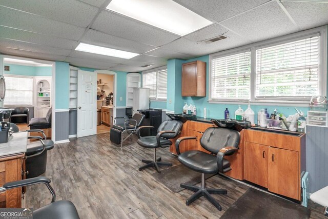 office area with wood-type flooring and a paneled ceiling