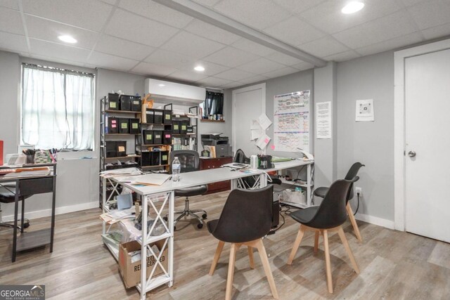 office space featuring light wood-type flooring and a drop ceiling