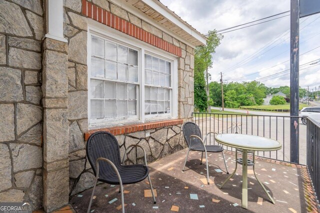 view of patio featuring a balcony