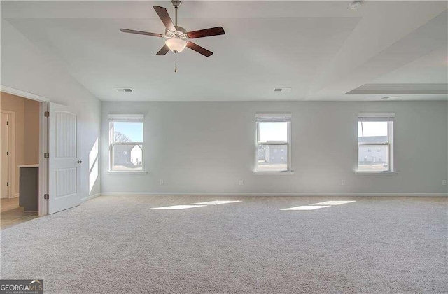 carpeted empty room featuring vaulted ceiling and ceiling fan