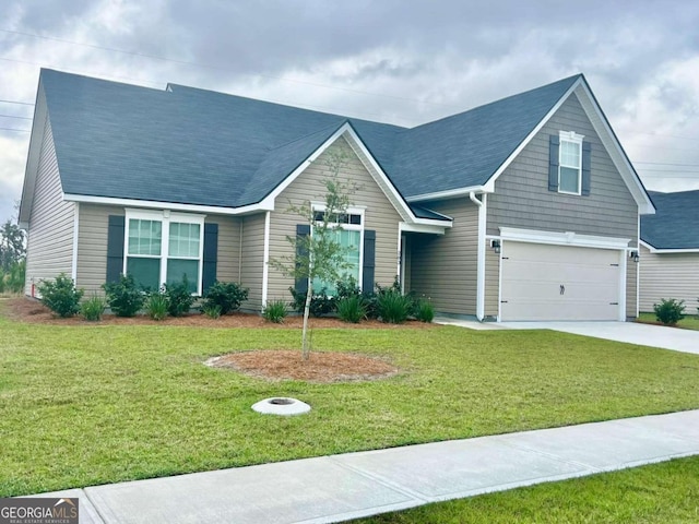 view of front of house with a front yard and a garage